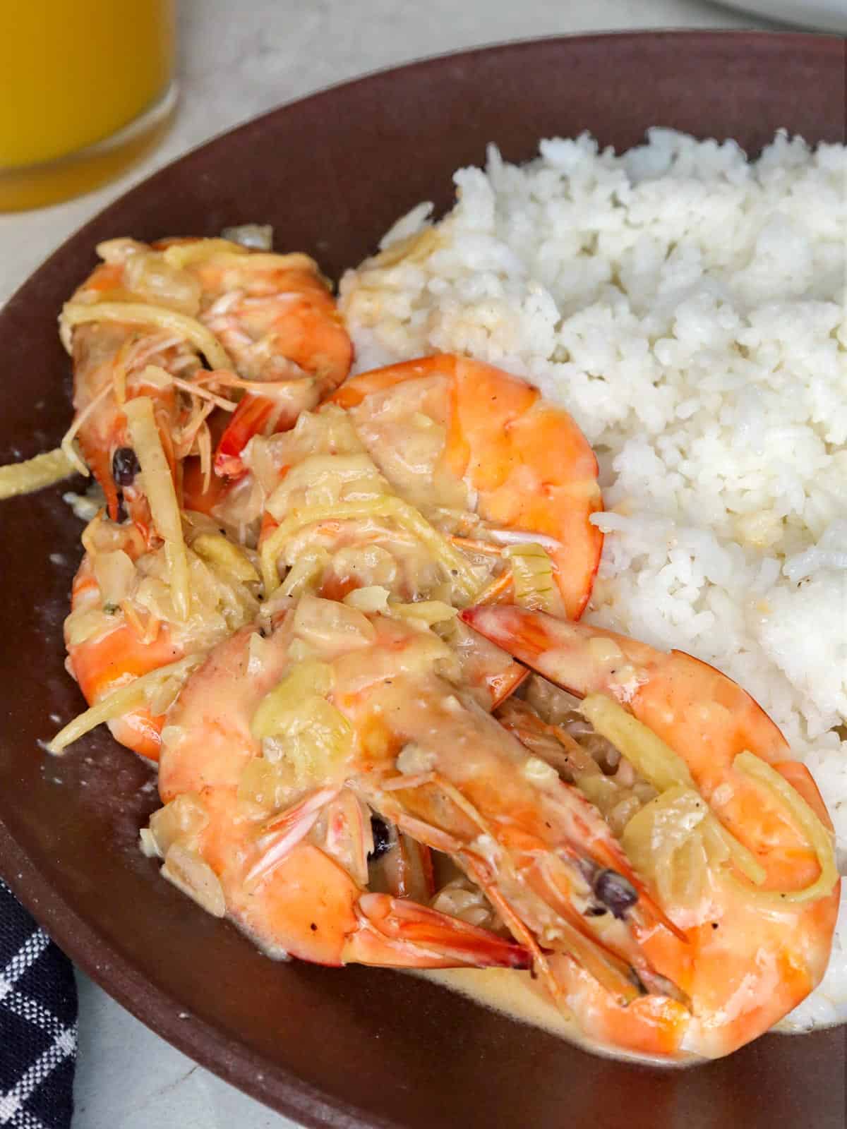 ginataang hipon on a wooden plate with steamed rice