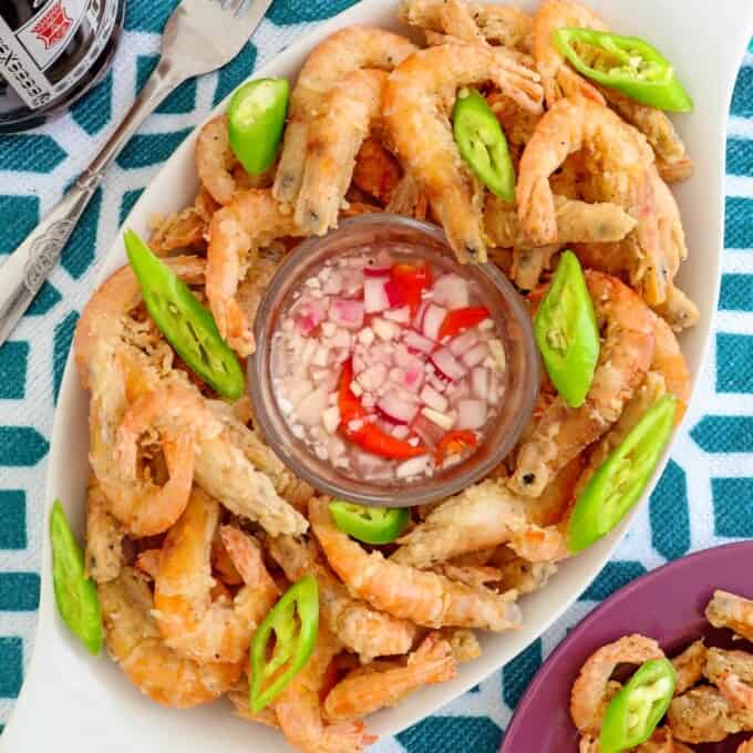 Crispy Fried Drunken Shrimp on a clear glass platter with spicy vinegar on the side