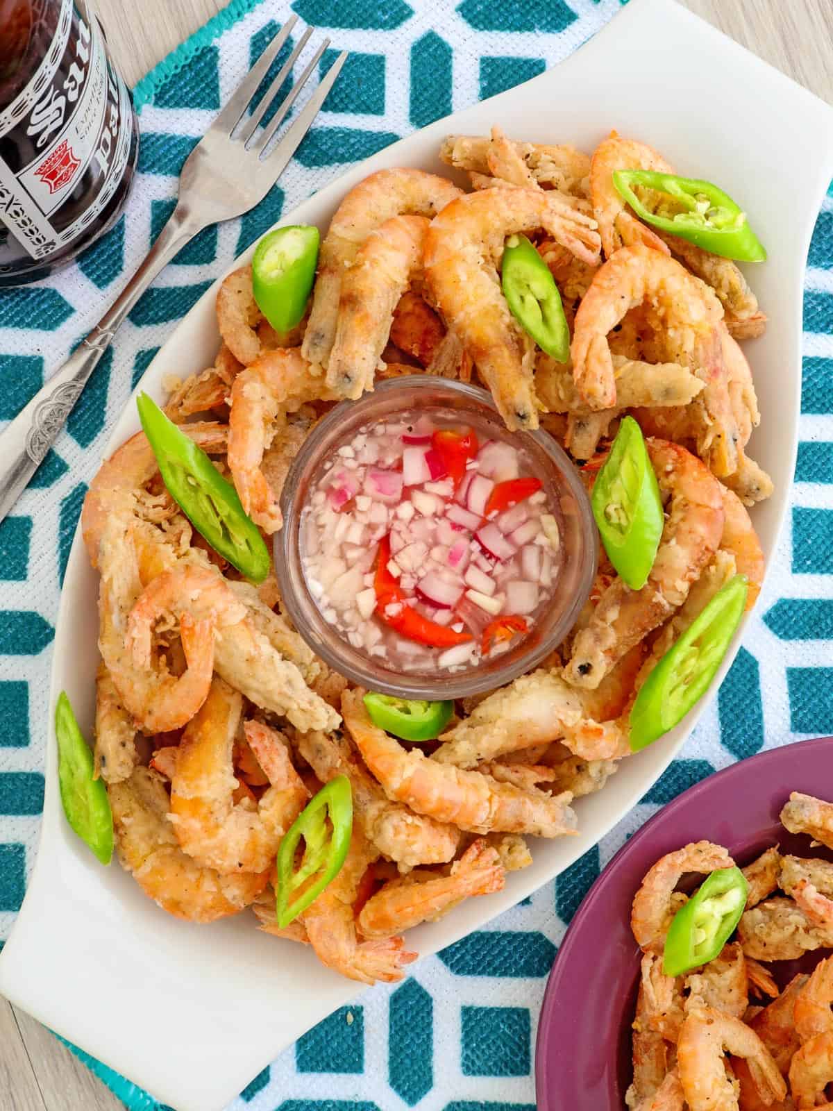 Crispy Fried Drunken Shrimp on a clear glass platter with spicy vinegar on the side