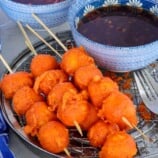 Kwek-Kwek in bamboo skewers with dipping sauce on the side