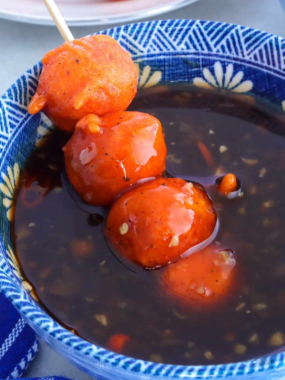 dipping kwek-kwek in sauce