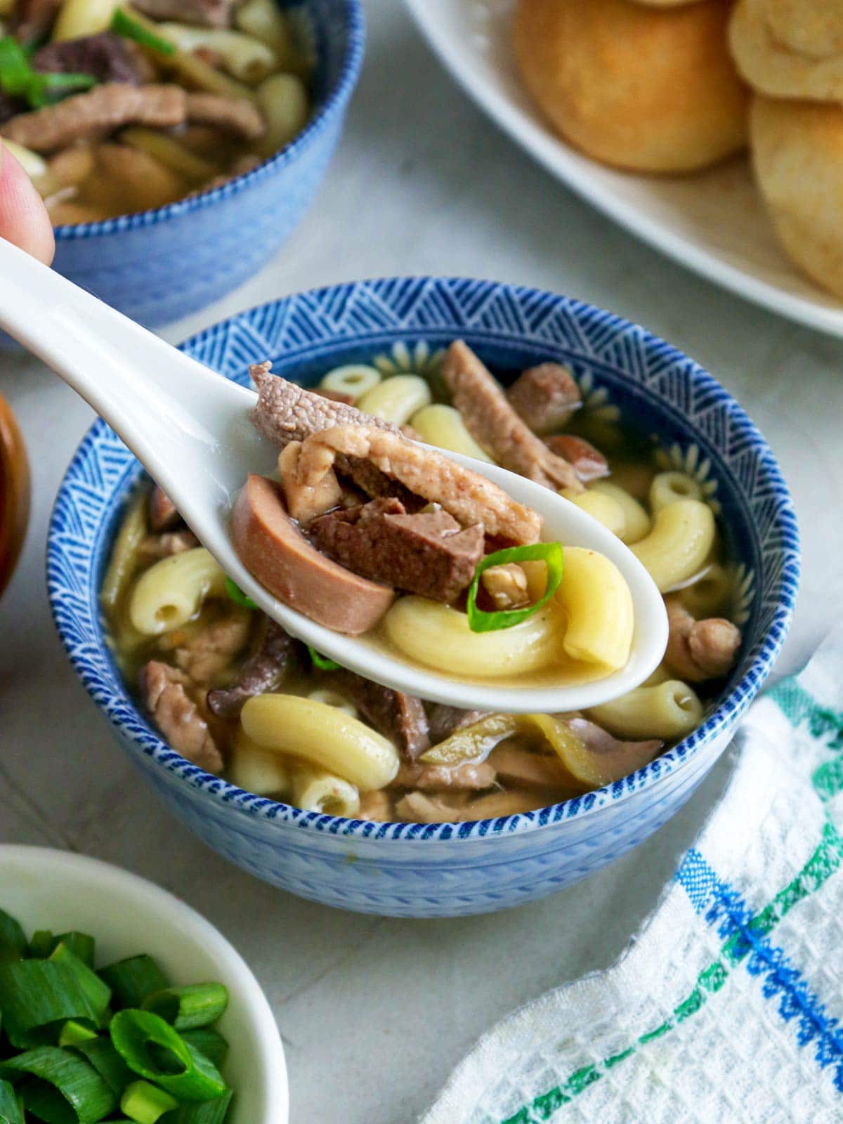 eating Batsui with a spoon from a blue bowl