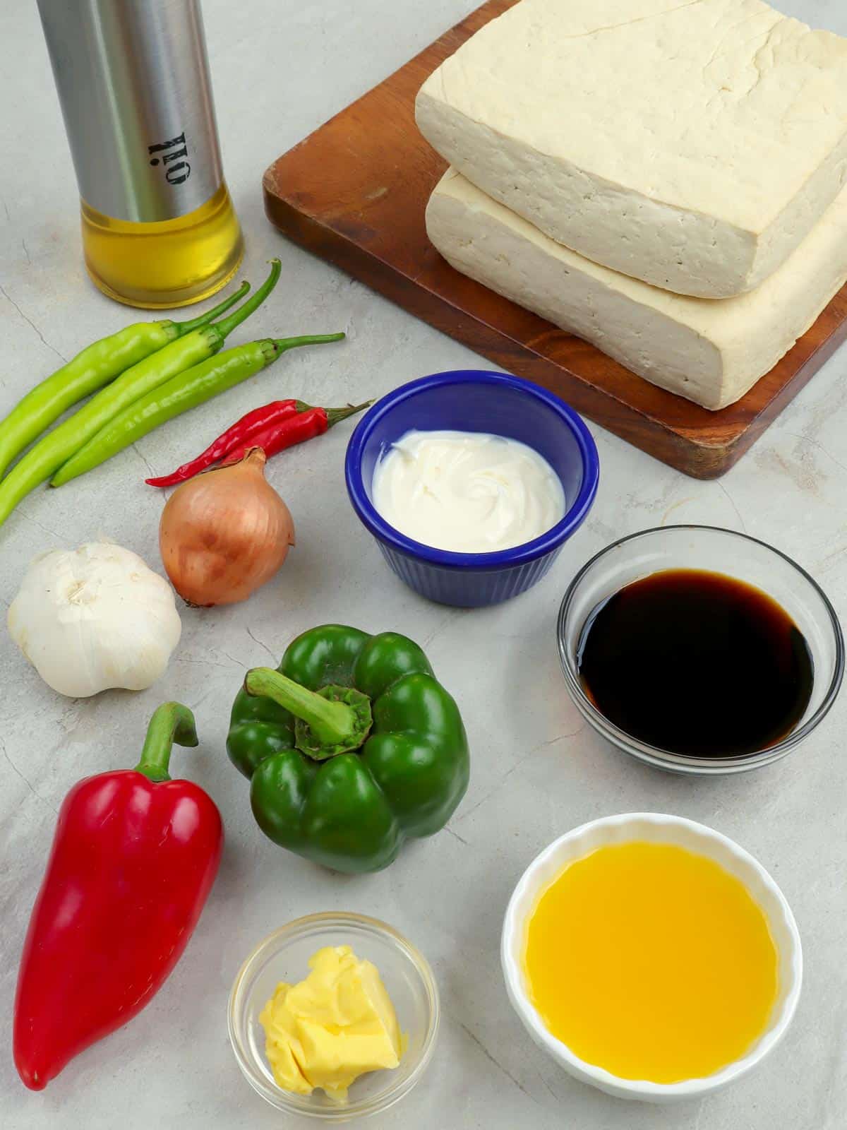 tofu blocks, bell peppers, onion, garlic, calamansi juice, Knorr seasoning, butter, chili pepper,   mayonnaise in bowls