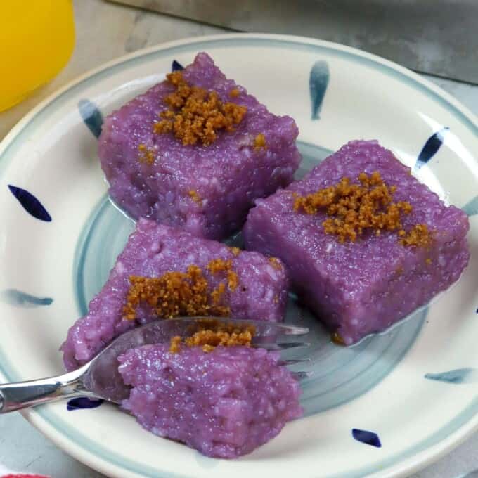 slices of biko with ube and latik on a blue printed plate