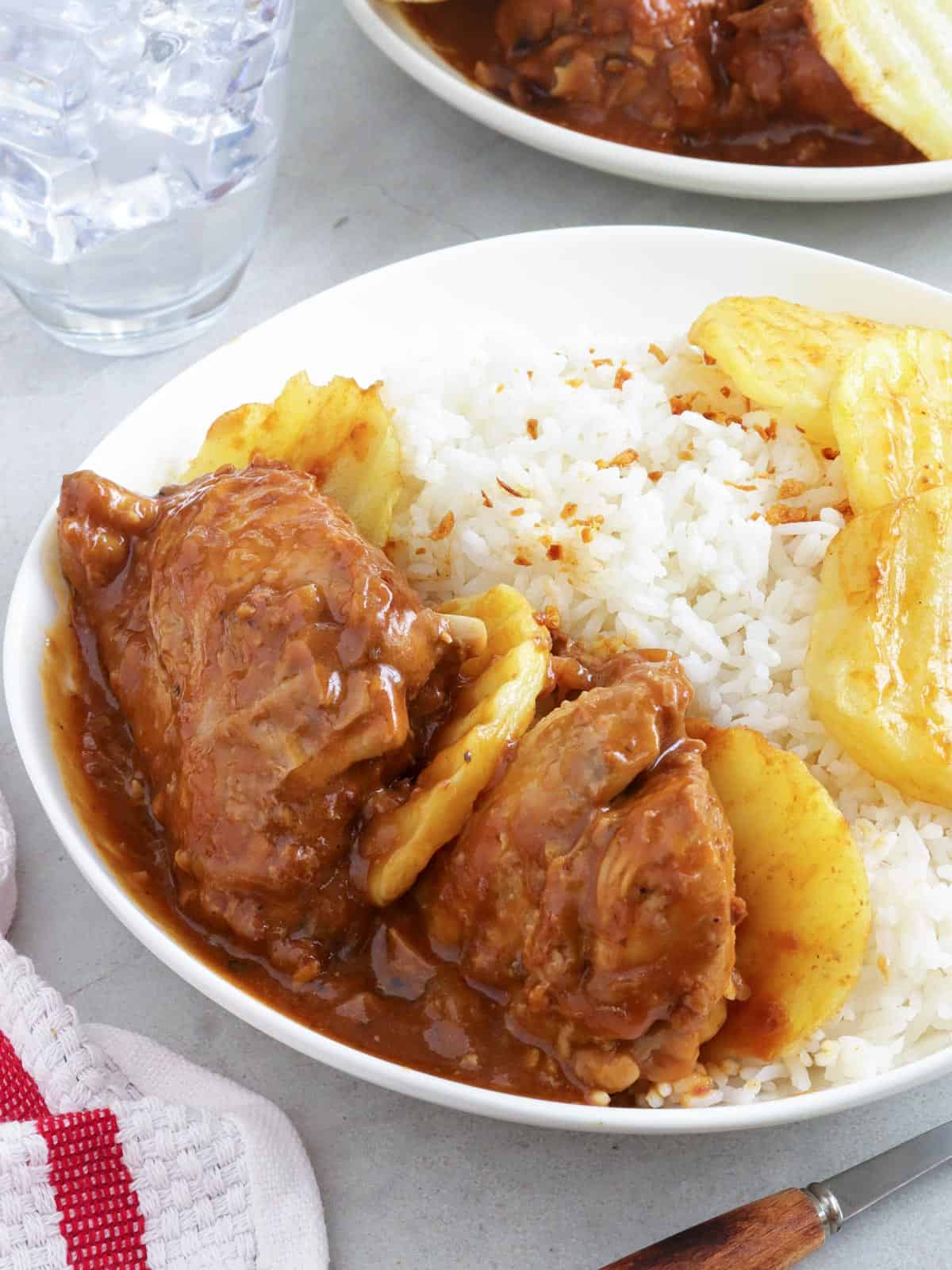 asadong manok with steamed rice on a white plate