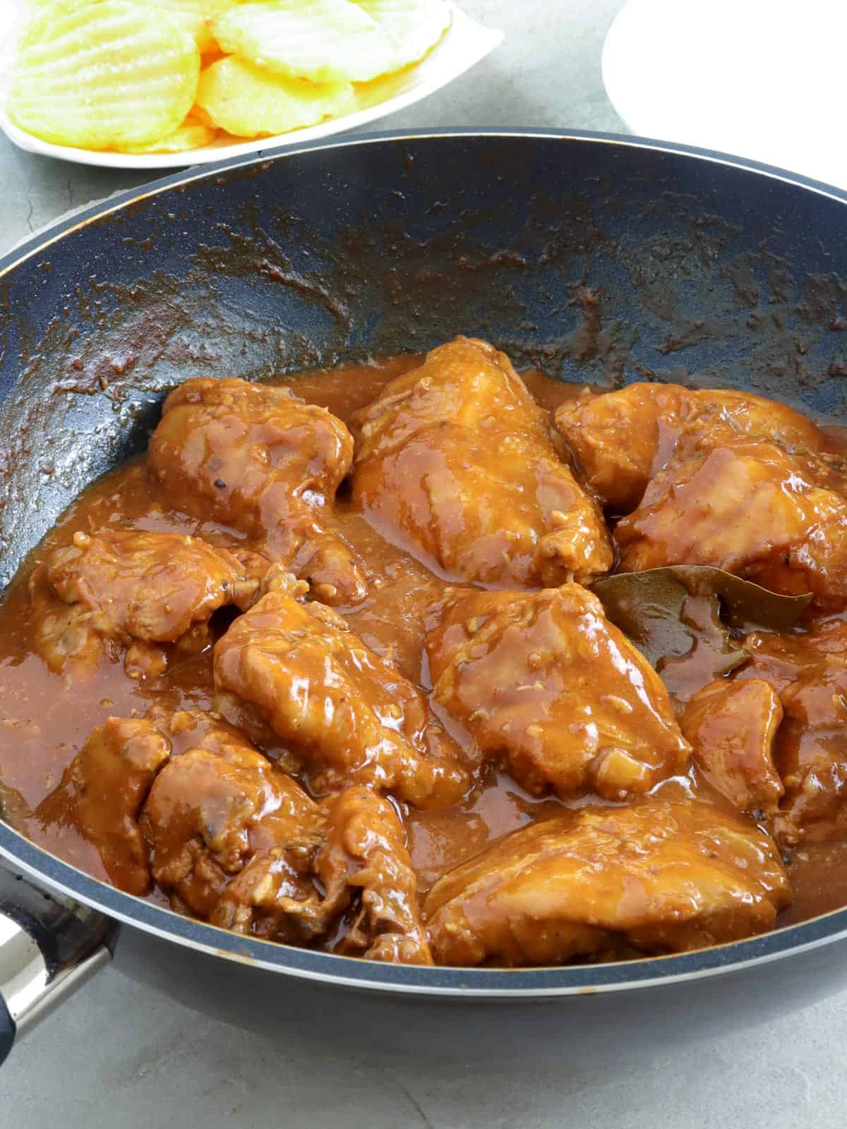 cooking chicken asado in a pan