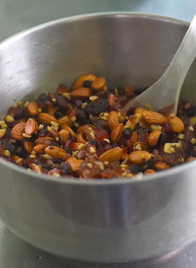 dried fruit and nuts soaking in brandy in a metal bowl