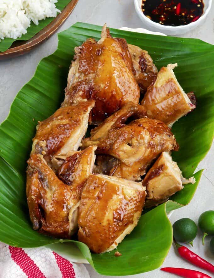 chopped lechon manok on a banana leaf lined serving platter