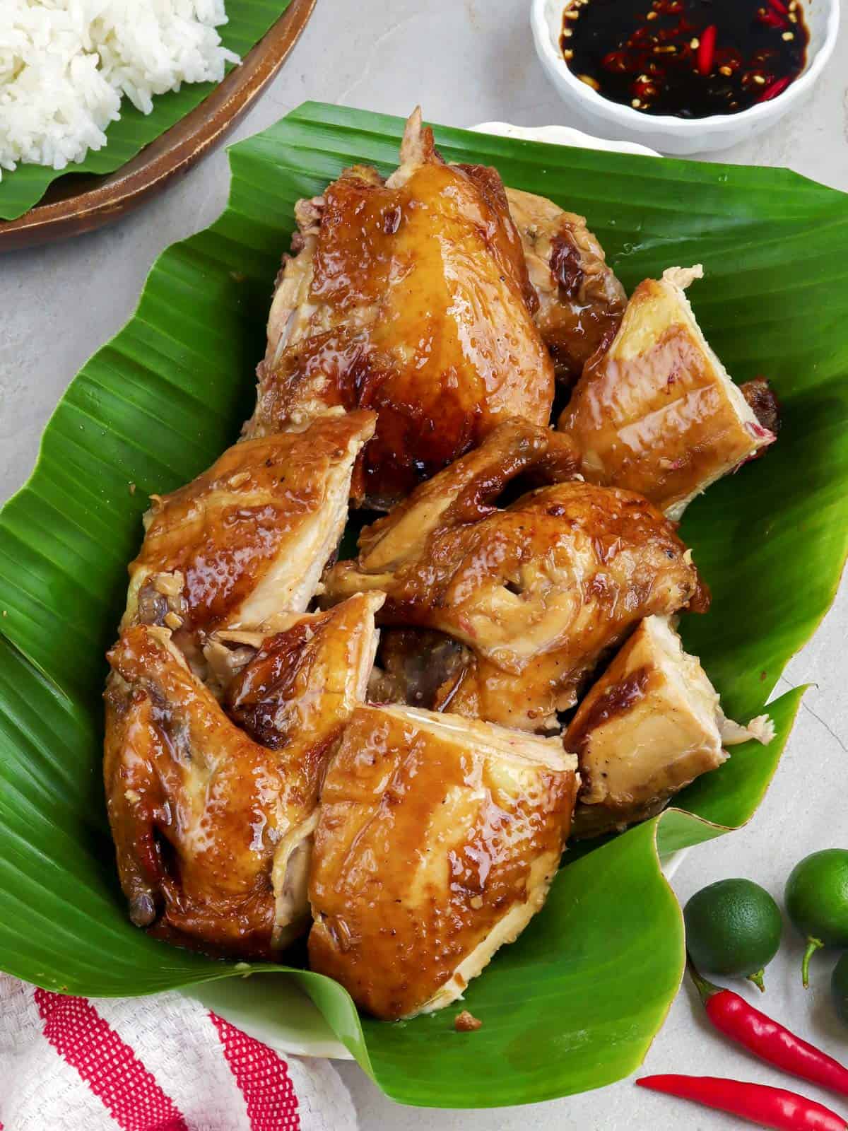 chopped lechon manok on a banana leaf lined serving platter