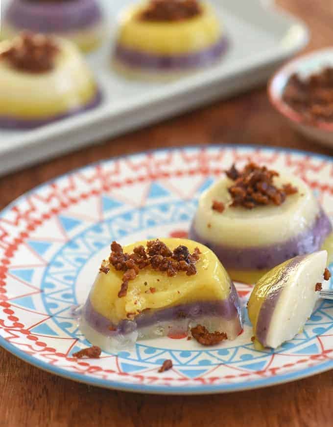 mini Filipino-style layered sticky rice cakes on a blue serving plate