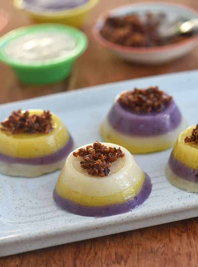 Mini Special Sapin-Sapin topped with latik on a serving platter