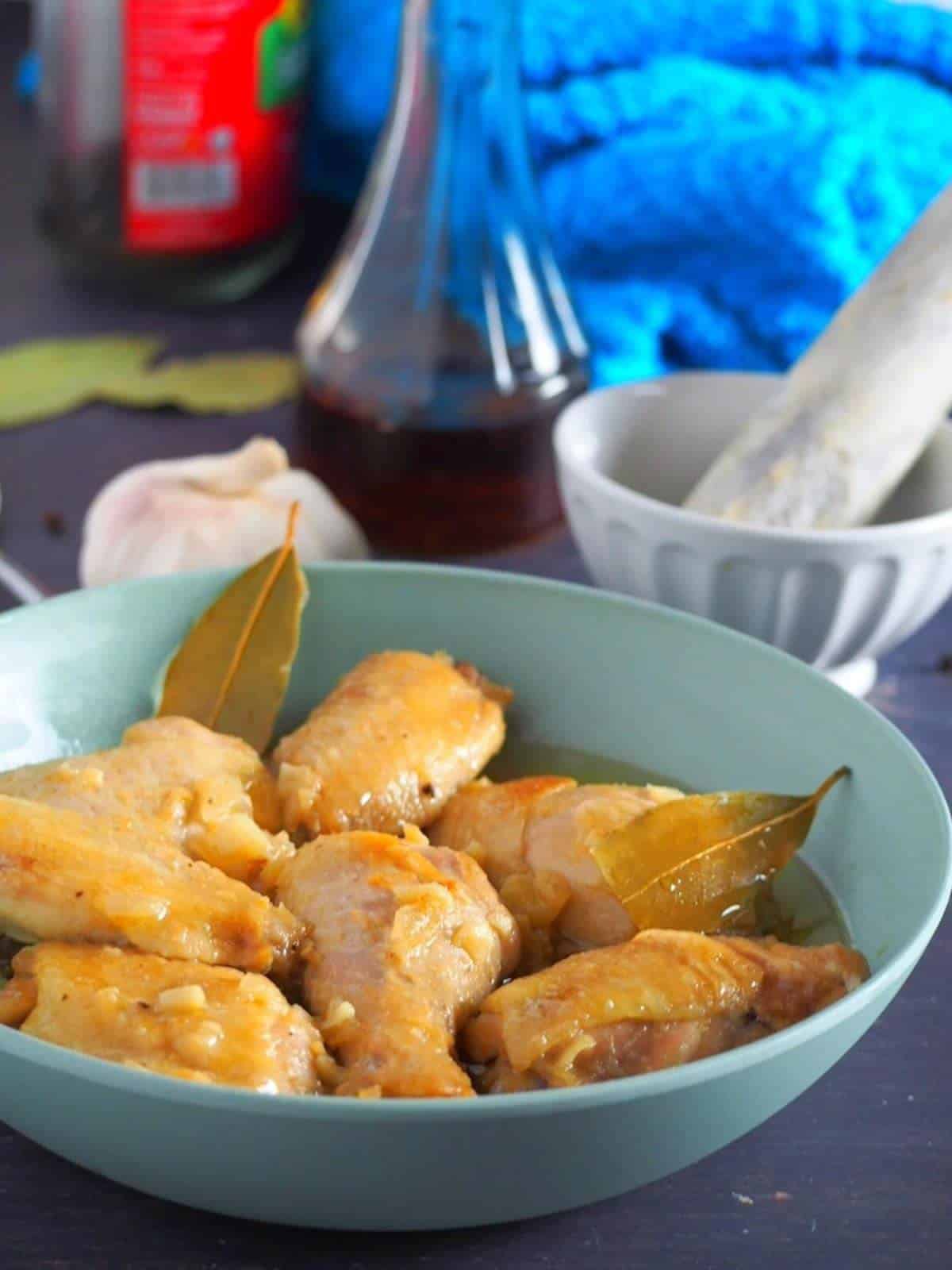 Adobong Manok sa Patis in a light blue serving bowl