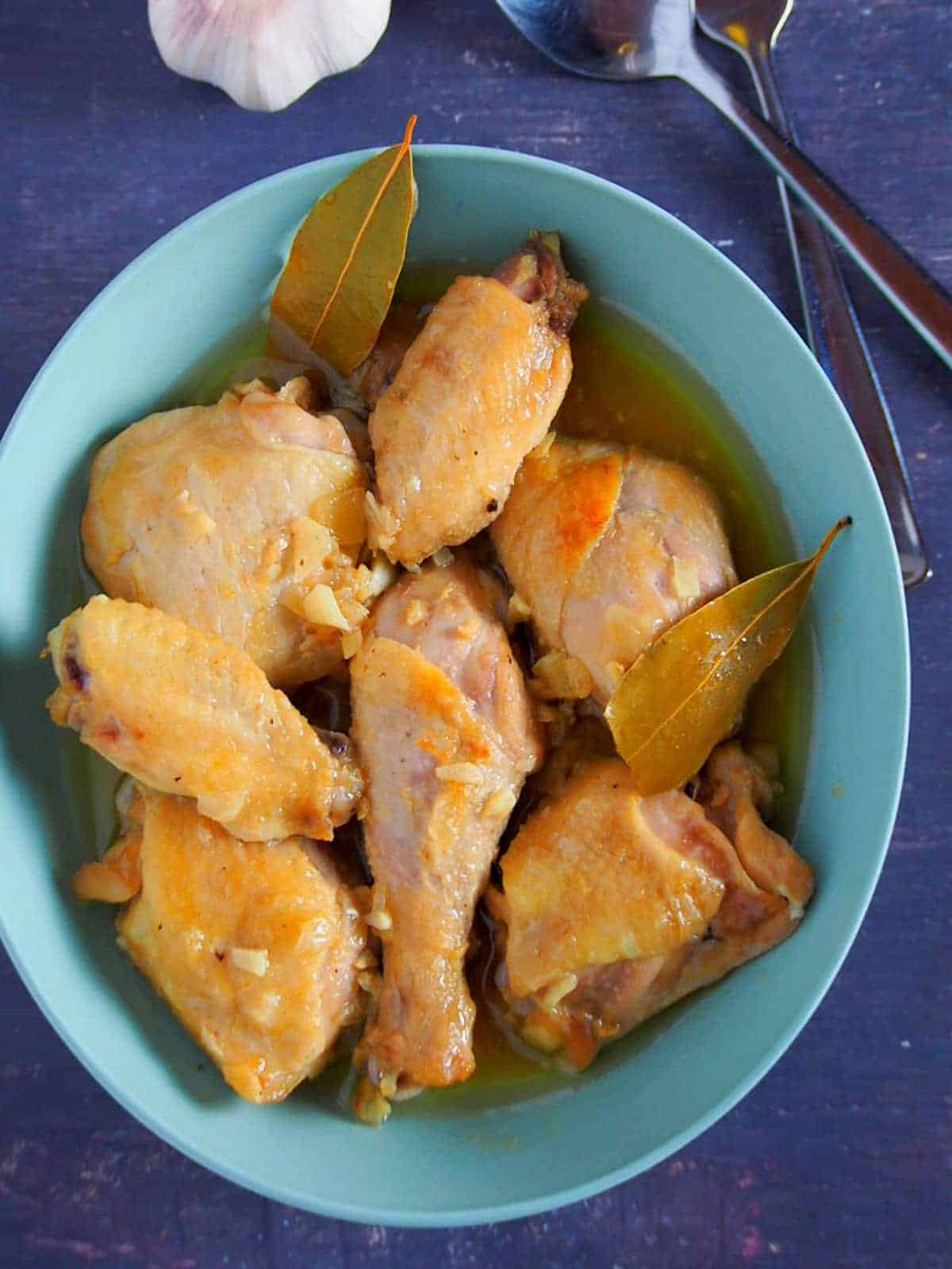 top view of Chicken Adobo with fish sauce on a blue bowl