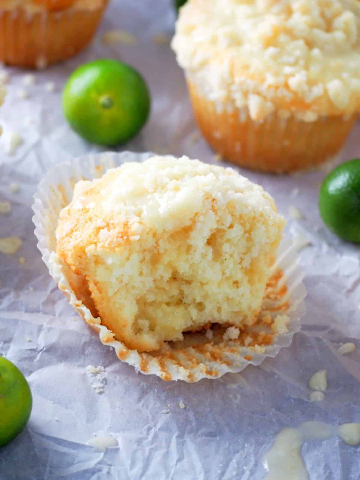 half of a citrus crumb muffin on a parchment paper
