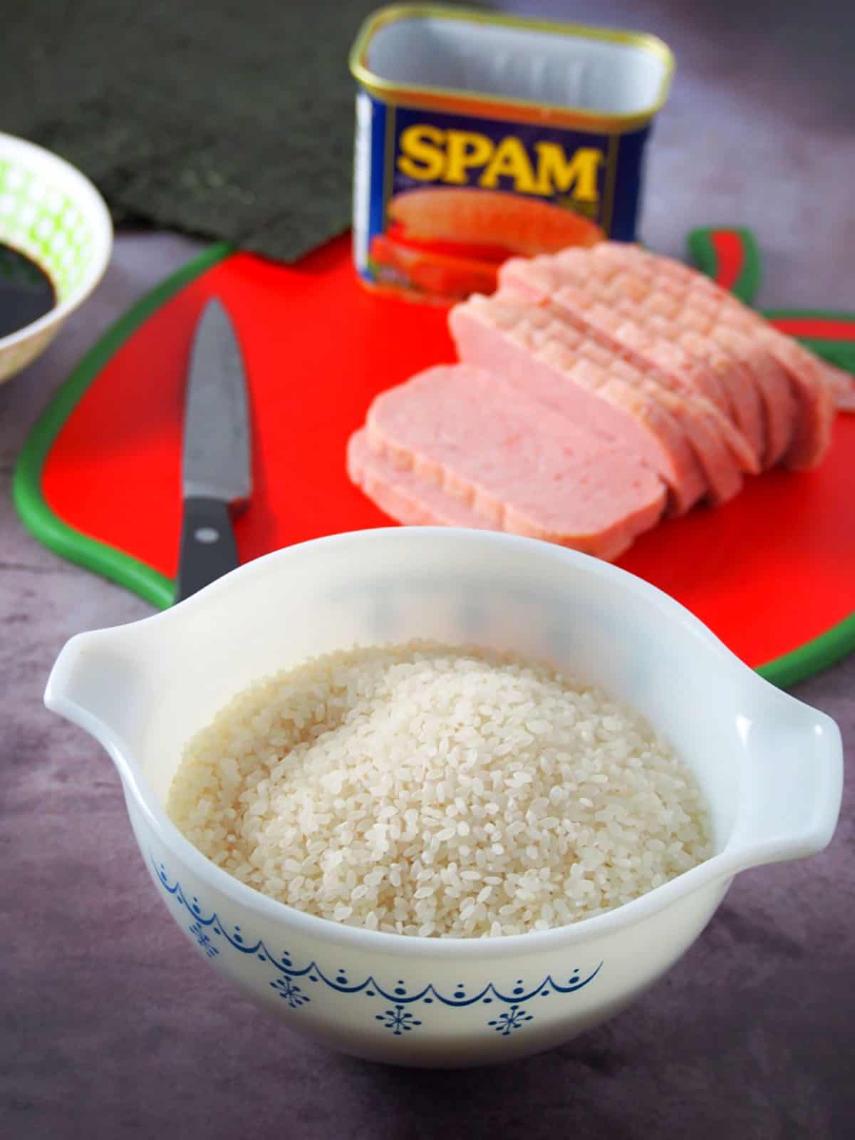 bowl of short-grain rice, slices of spam, and soy sauce