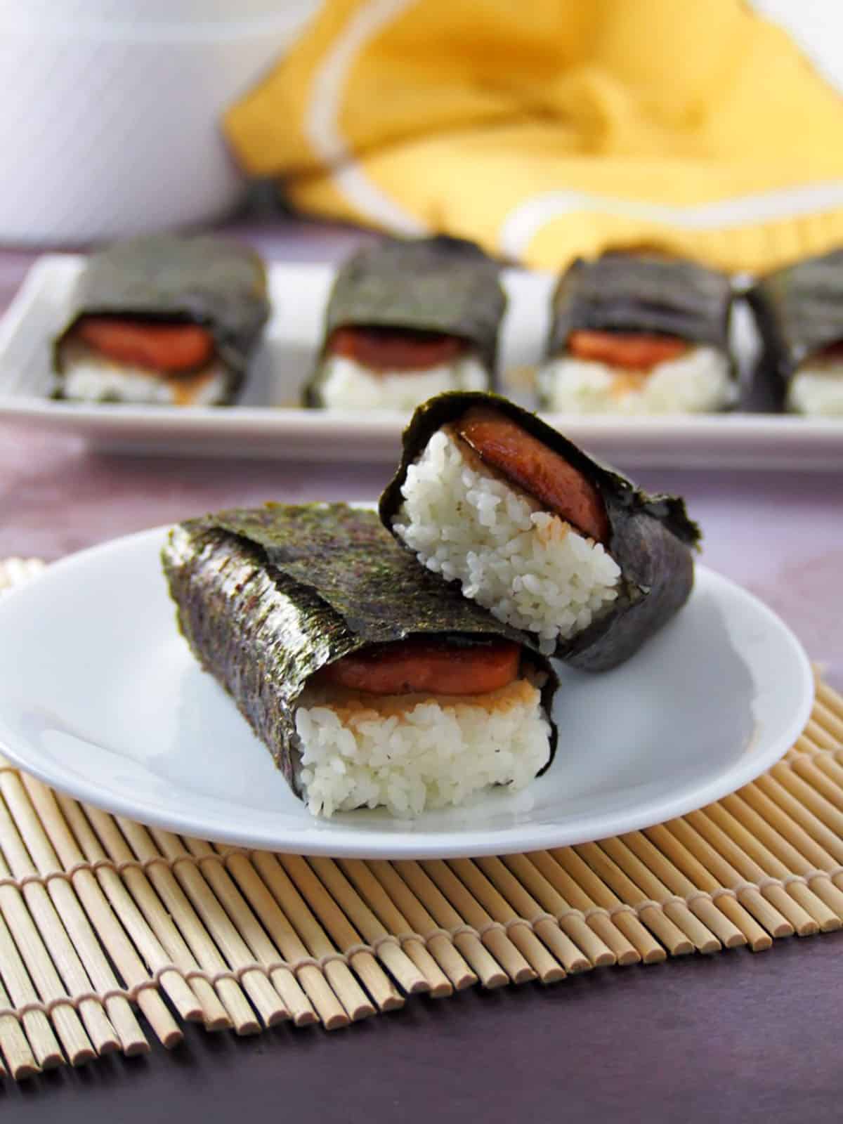 two spam musubi on a white serving plate
