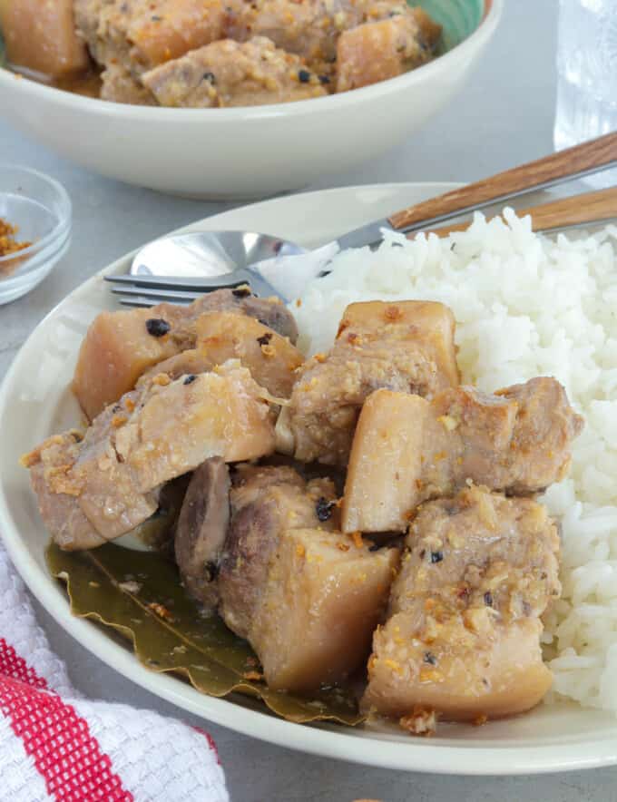 White pork adobo on a plate with steamed rice.