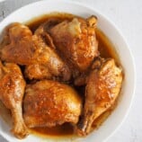 top view of adobong manok with liver spread in a white serving bowl