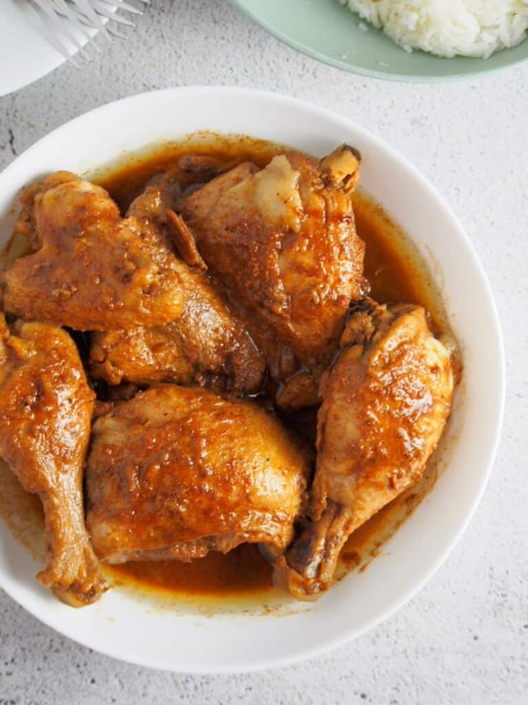 top view of adobong manok with liver spread in a white serving bowl