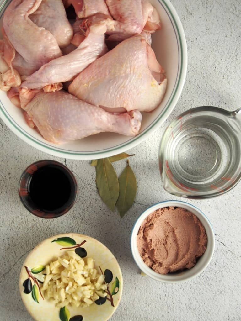 cut up bone-in chicken, vinegar, garlic, bay leaf, and liver spread