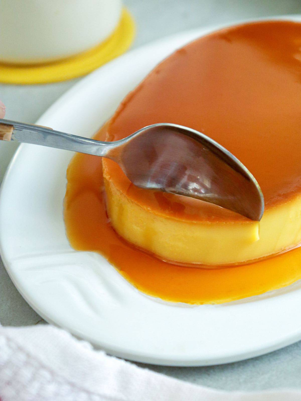 serving leche flan with a spoon