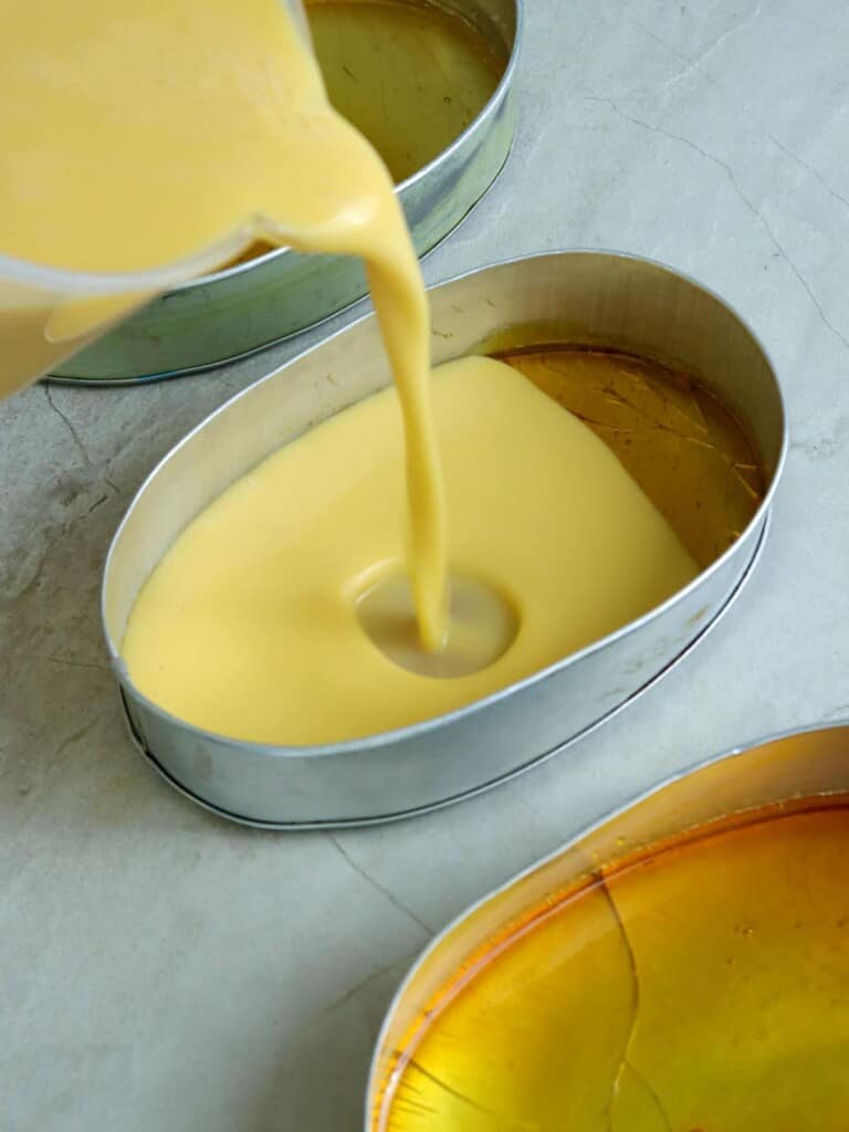 pouring leche flan mixture in llanera