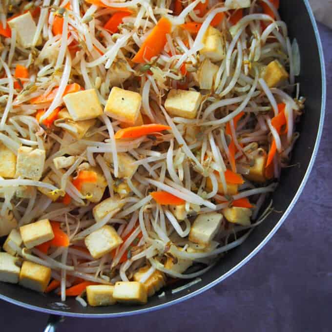 bean sprouts and tofu stir-fry in a wide pan