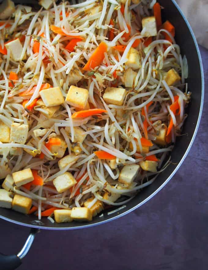 bean sprouts and tofu stir-fry in a wide pan