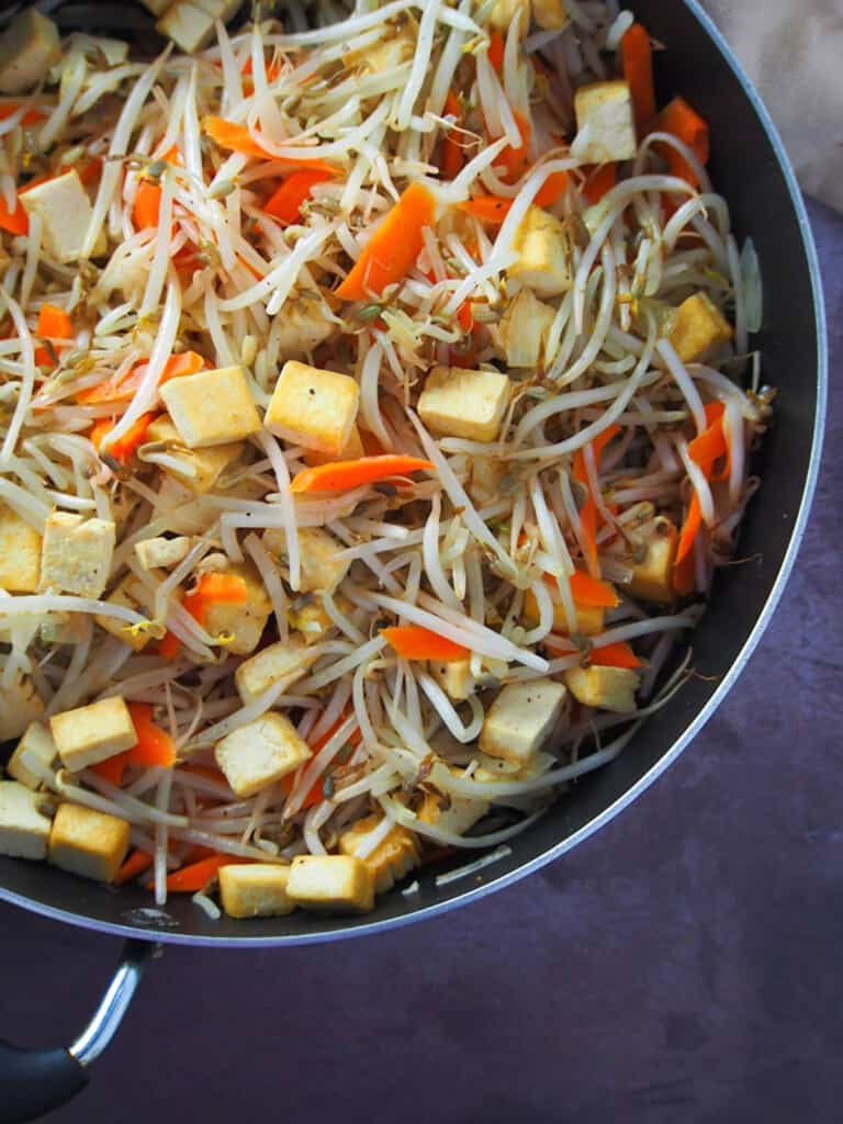 bean sprouts and tofu stir-fry in a wide pan