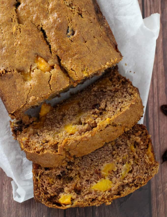 sliced mango bread loaf on a white cutting board