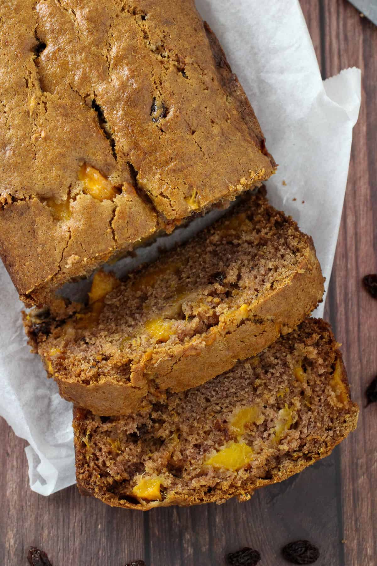 sliced mango bread loaf on a white cutting board