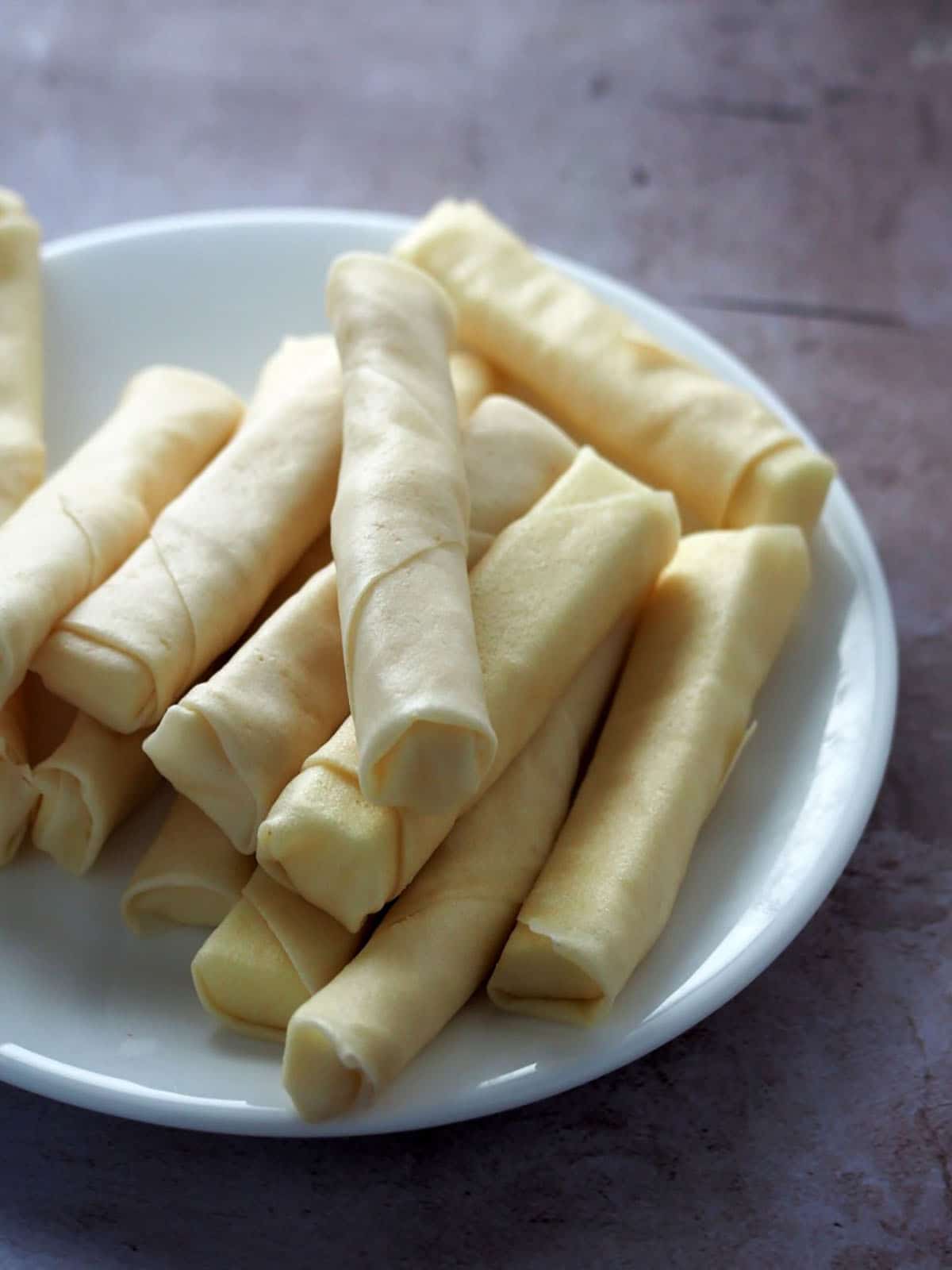 spring rolls filled with cheese on a white plate