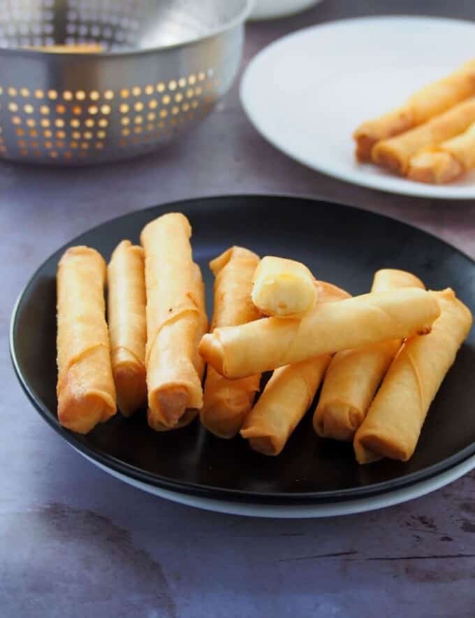 Cheese Sticks on a black plate