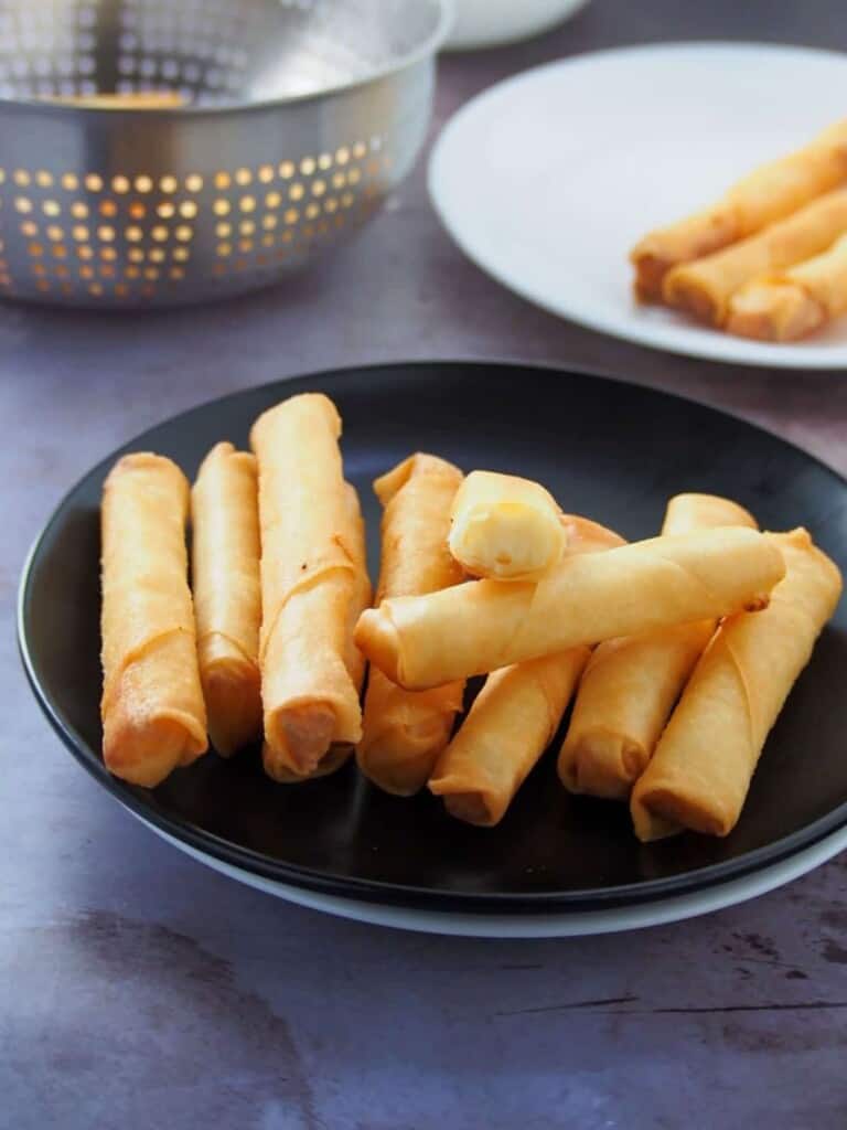 Cheese Sticks on a black plate