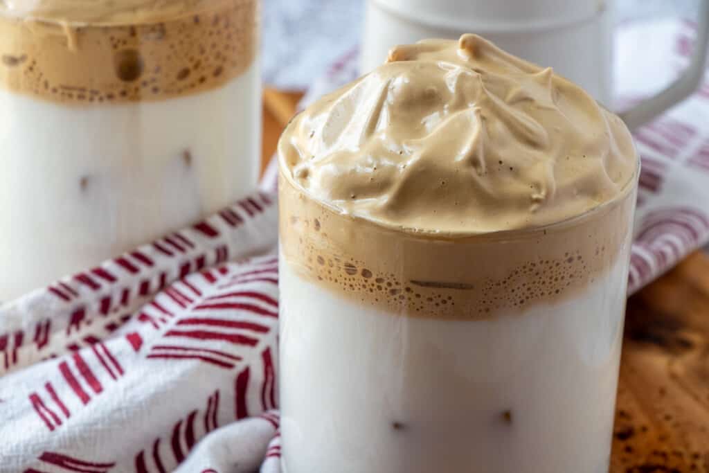 milk topped with whipped coffee in a glass mug