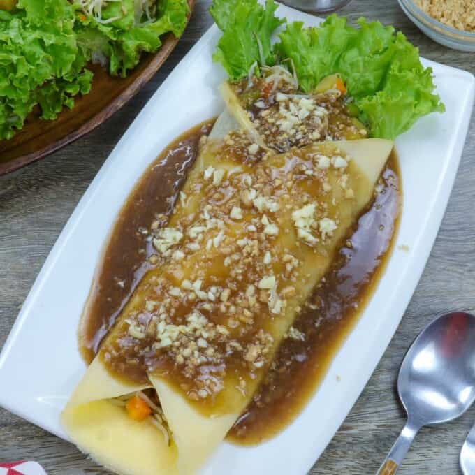 Lumpiang Sariwa with peanut sauce on a blue plate