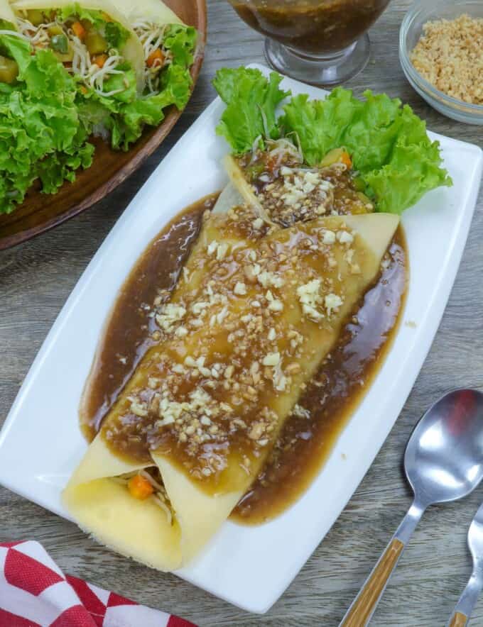 Lumpiang Sariwa with peanut sauce on a blue plate