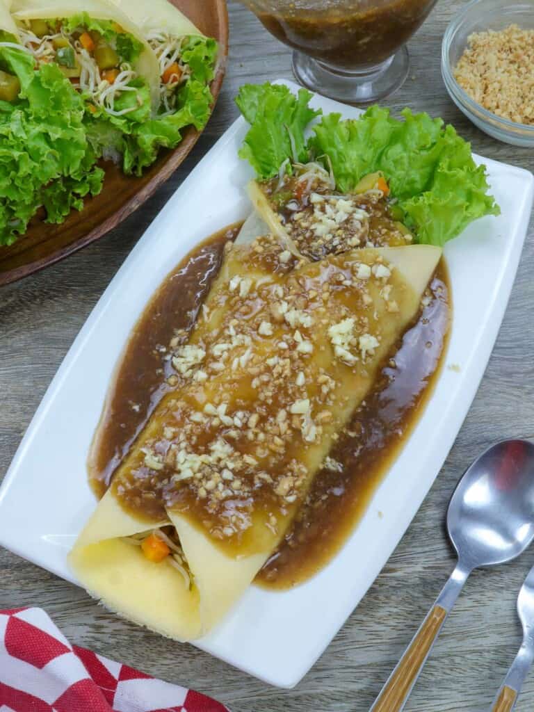 Lumpiang Sariwa with peanut sauce on a blue plate