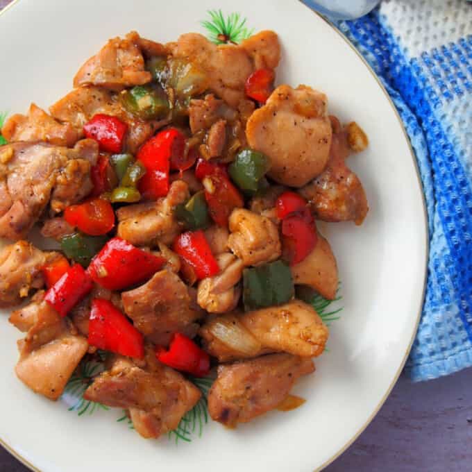 Chinese Black Pepper Chicken Stir-fry with bell peppers on a white serving platter