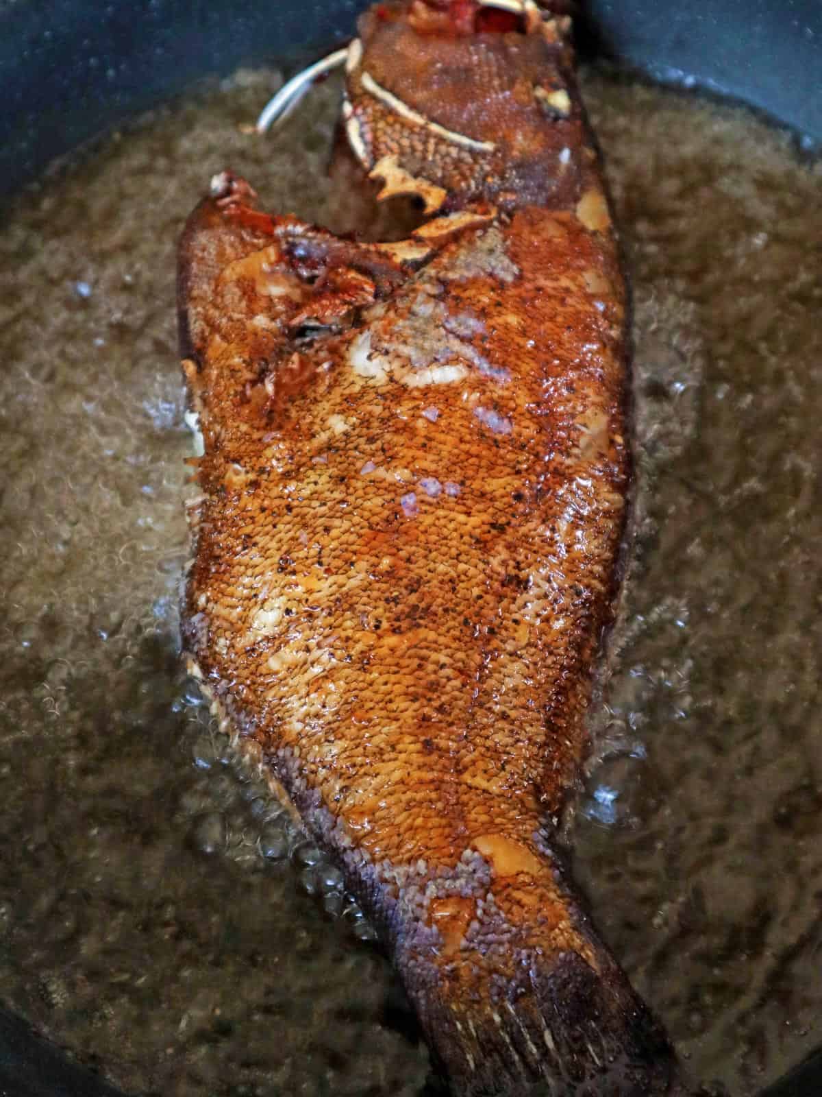 lapu-lapu frying in hot oil in a pan