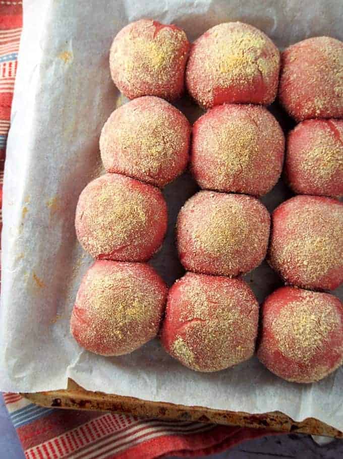 Red Velvet Pandesal on a baking sheet