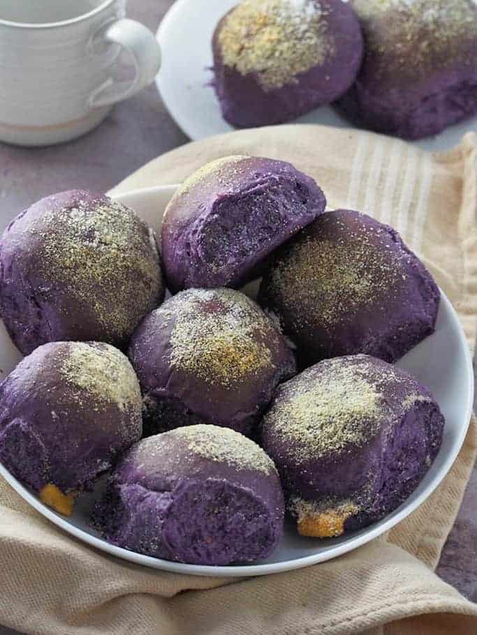 ube cheese pandesal on a white plate