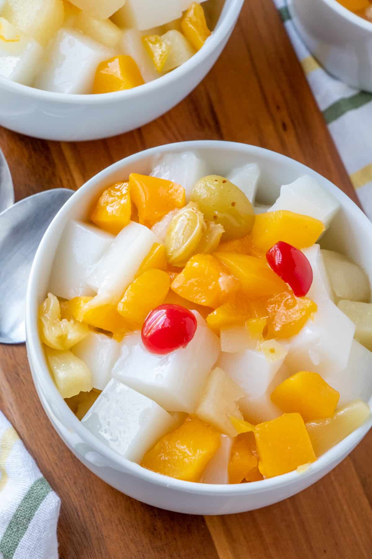 Almond Jello with fruit cocktail in a white bowl