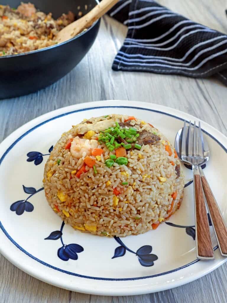 House Special Fried Rice on a serving plate with fork and spoon