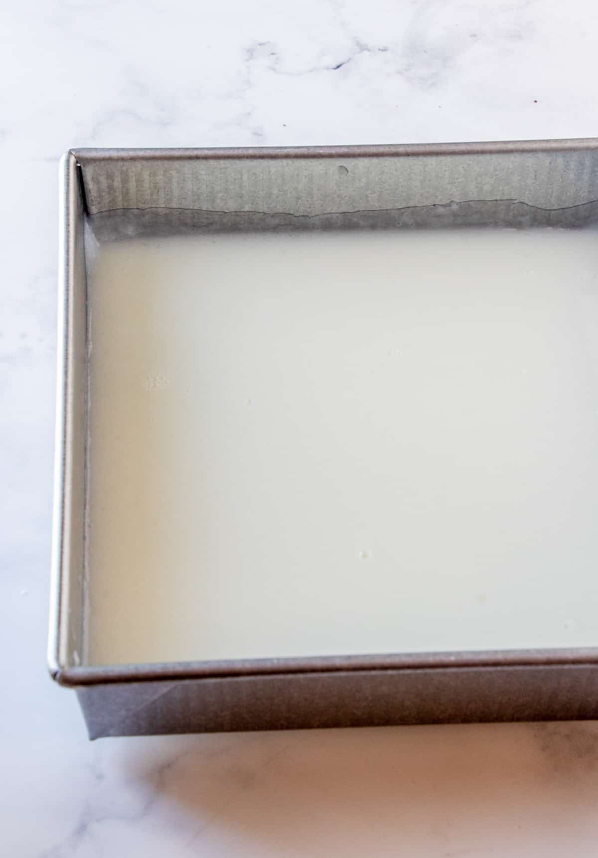 almond or annin tofu setting in a square metal pan