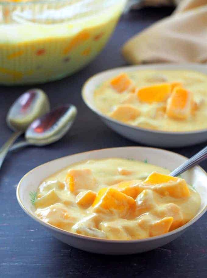 diced mango, kaong, nata de coco, and sweetened cream in a serving bowl