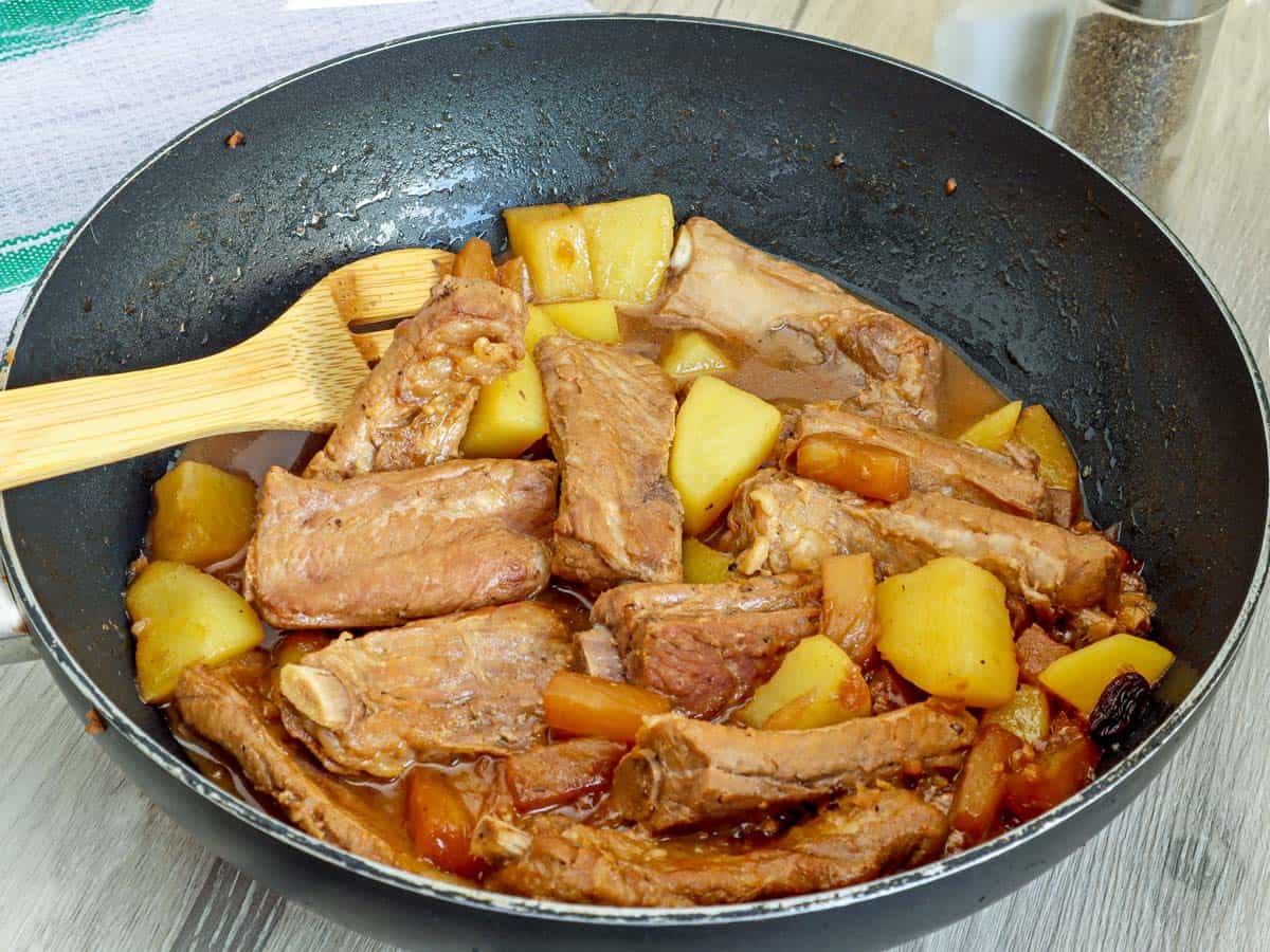 pork ribs with pineapple in a wide pan