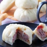 sliced siopao with meatball filling on a plate