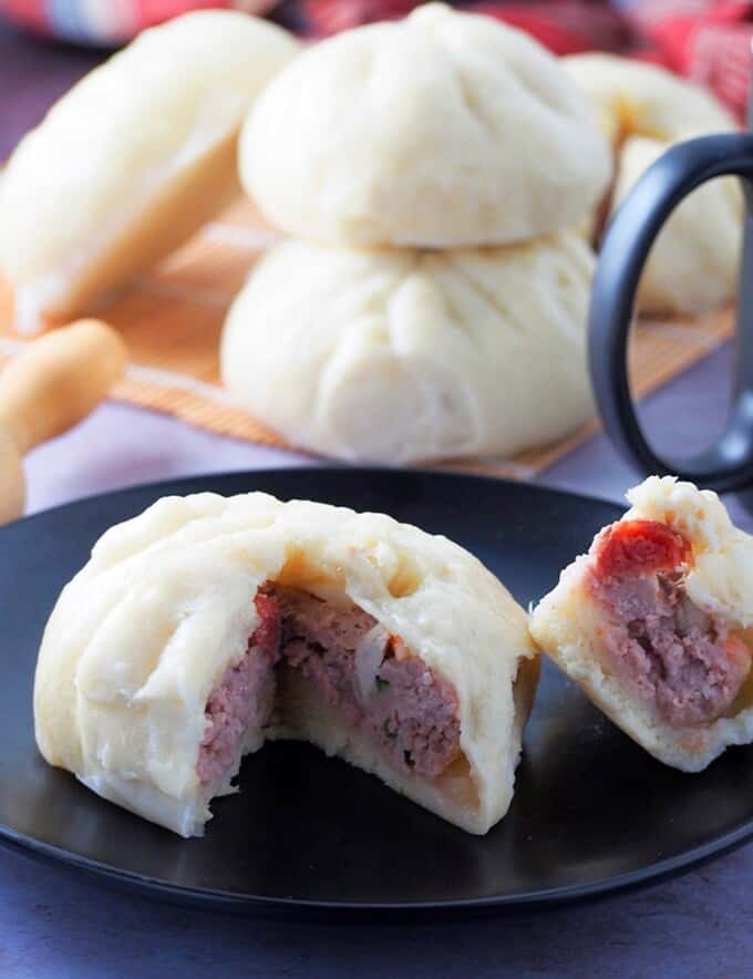 sliced siopao with meatball filling on a plate