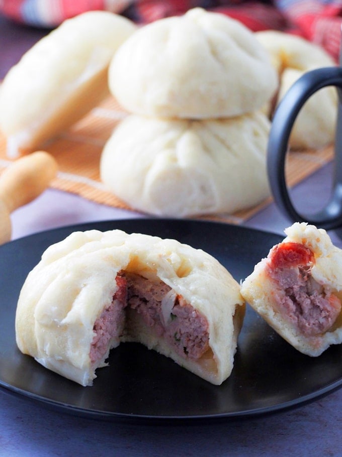 sliced siopao with meatball filling on a plate